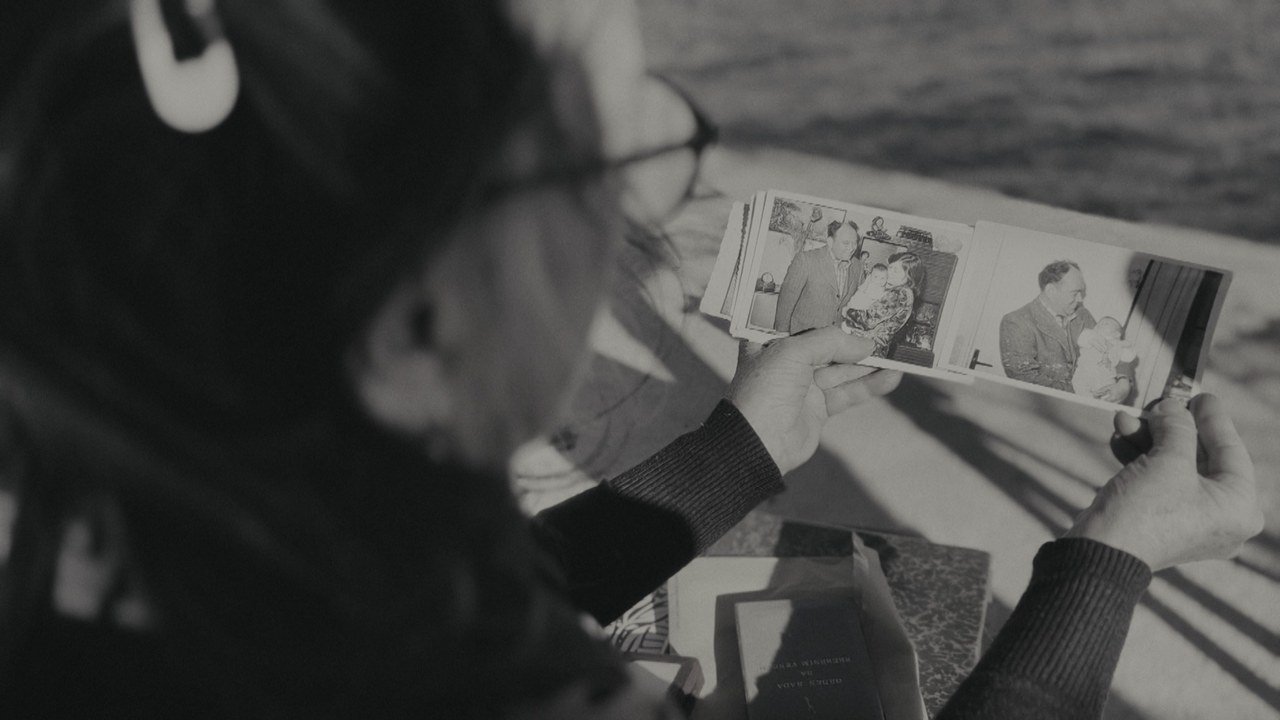 A woman holding old family photographs