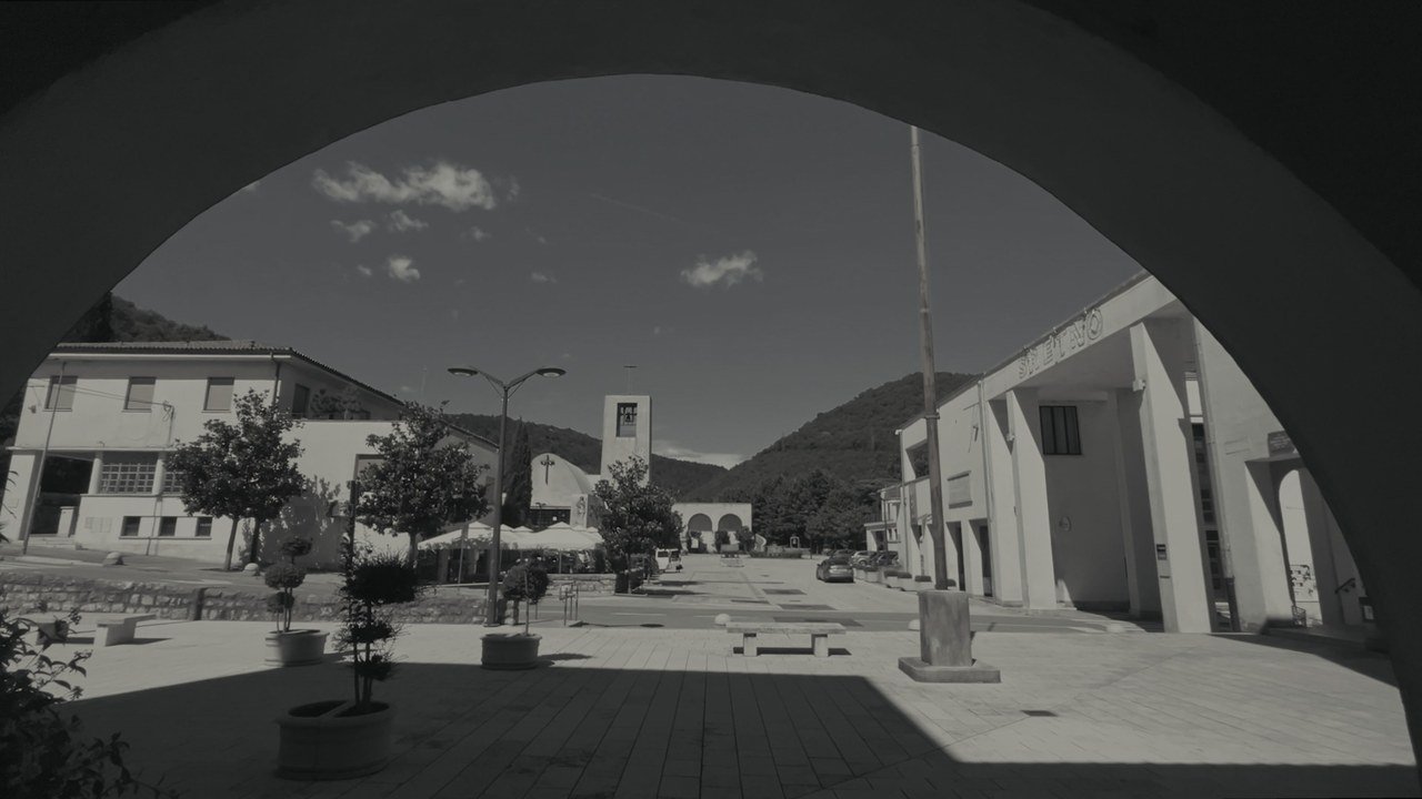 The central square of Raša seen through an arch